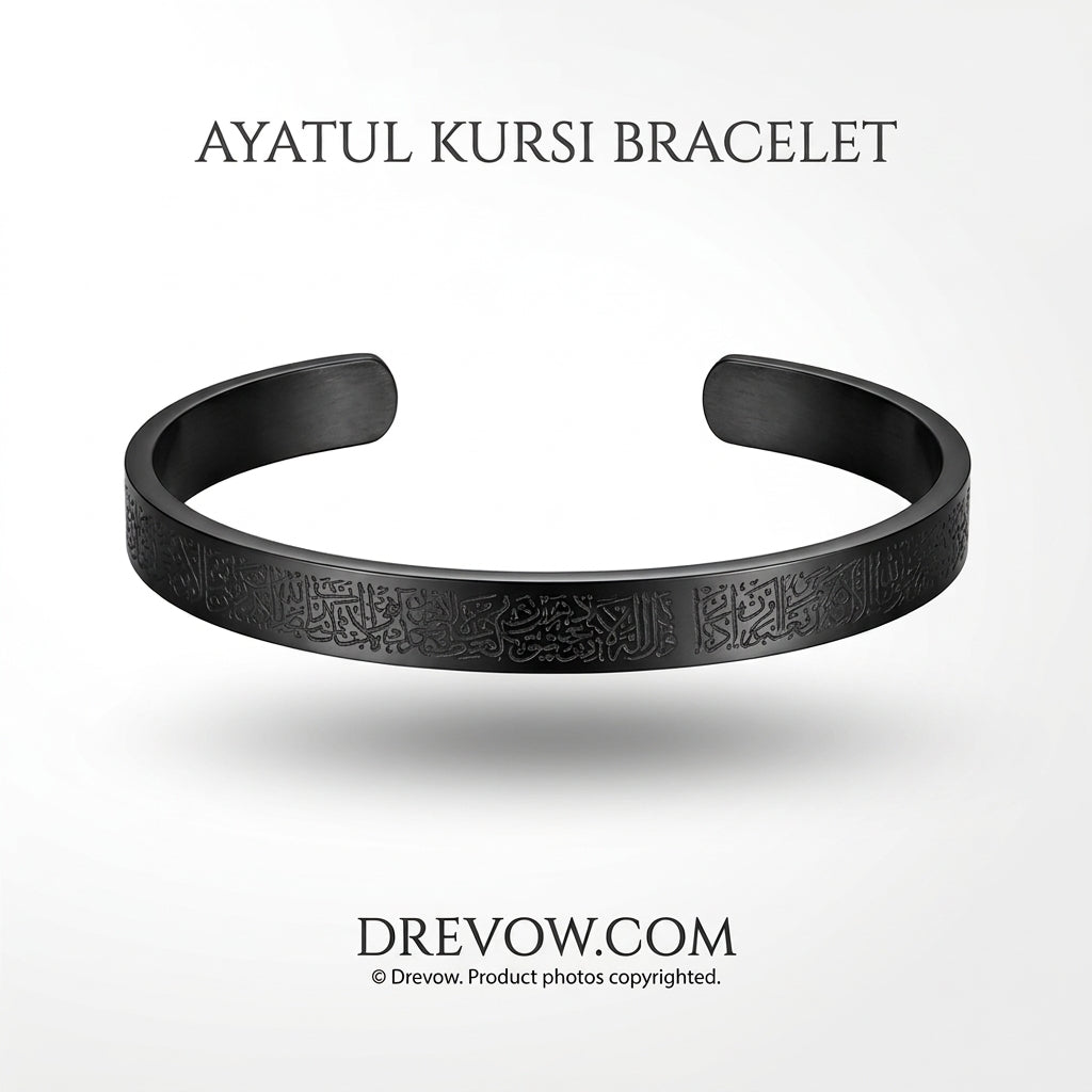 A matte black Ayatul Kursi open cuff bracelet with engraved Arabic calligraphy, shown on a light gray background with 'AYATUL KURSI BRACELET' text above and 'DREVOW.COM' text below.